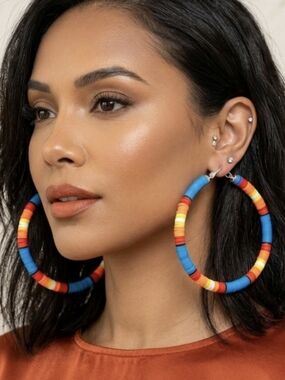 Extra-large hoop earrings featuring Heishi clay beads, boasting a boho-retro sty